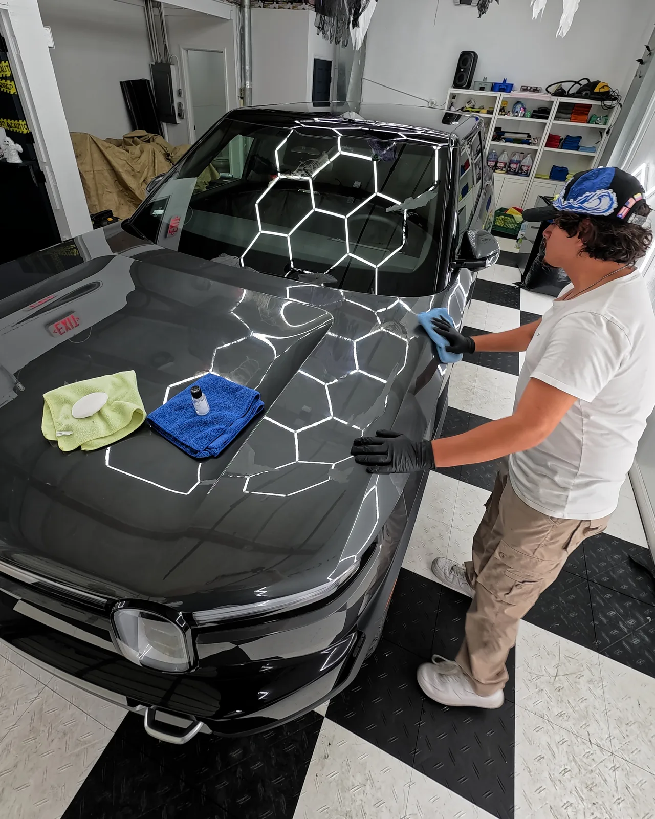 Oka coating the hood of the Rivian R2 — Oka's Car Care, Mountain View
