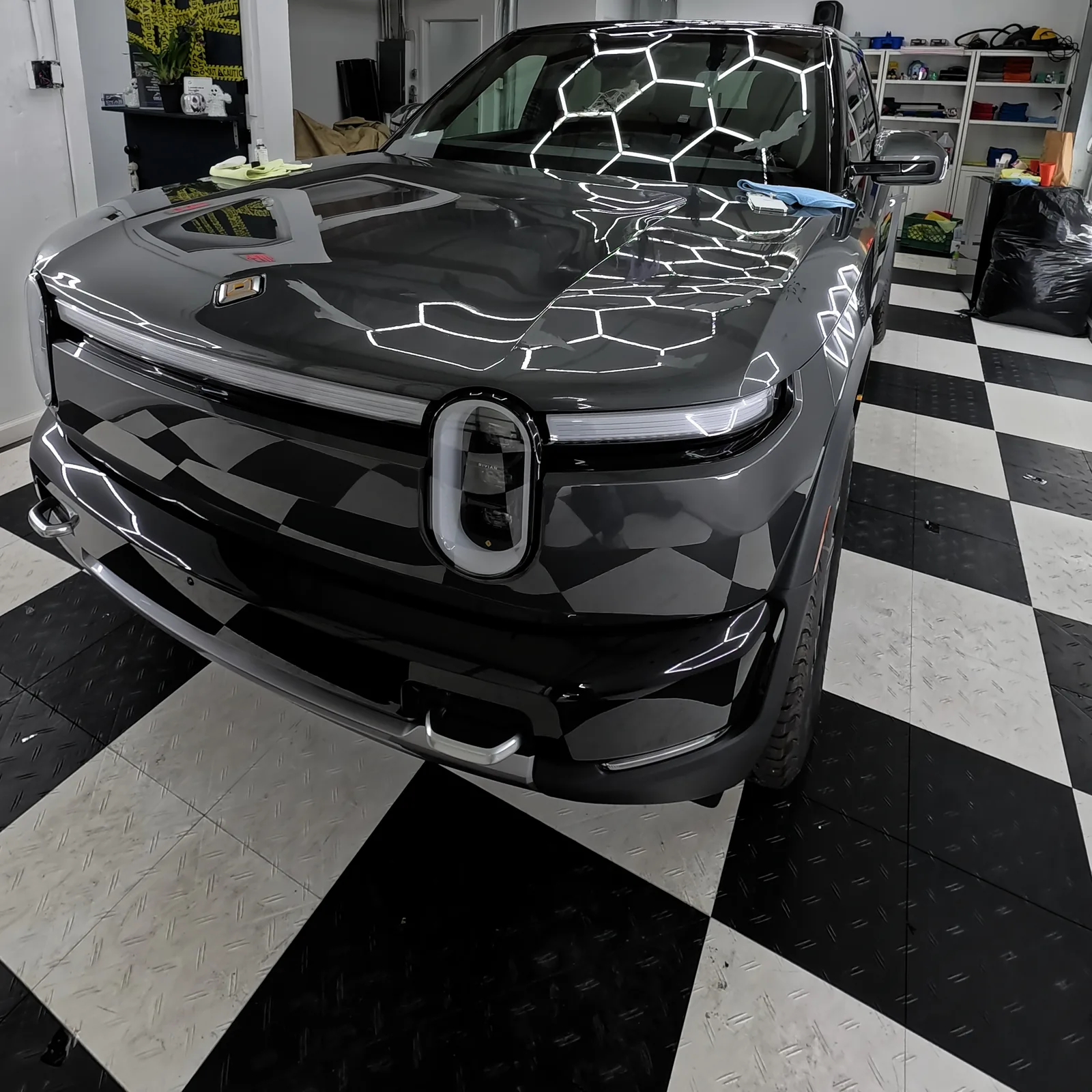 The front end of the finished Rivian R2, the ceiling lights across the hood — Oka's Car Care, Mountain View