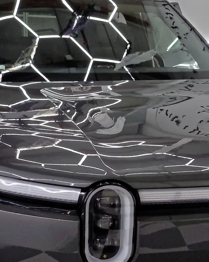 Rivian R2 headlight and the front of the hood, close — Oka's Car Care, Mountain View