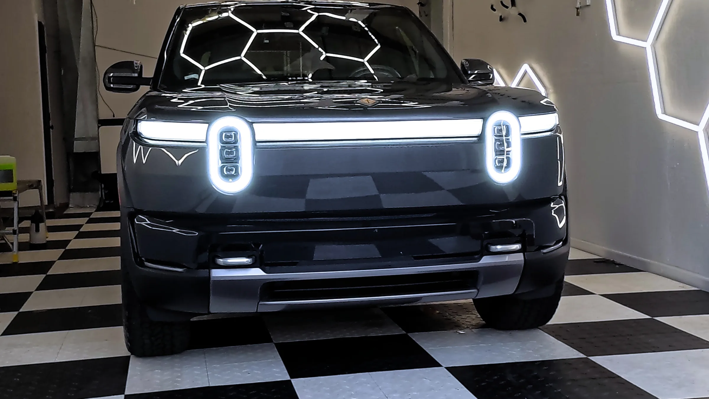 Rivian R2 from the front, lights on, after full front paint protection film and a ceramic coating — Oka's Car Care, Mountain View